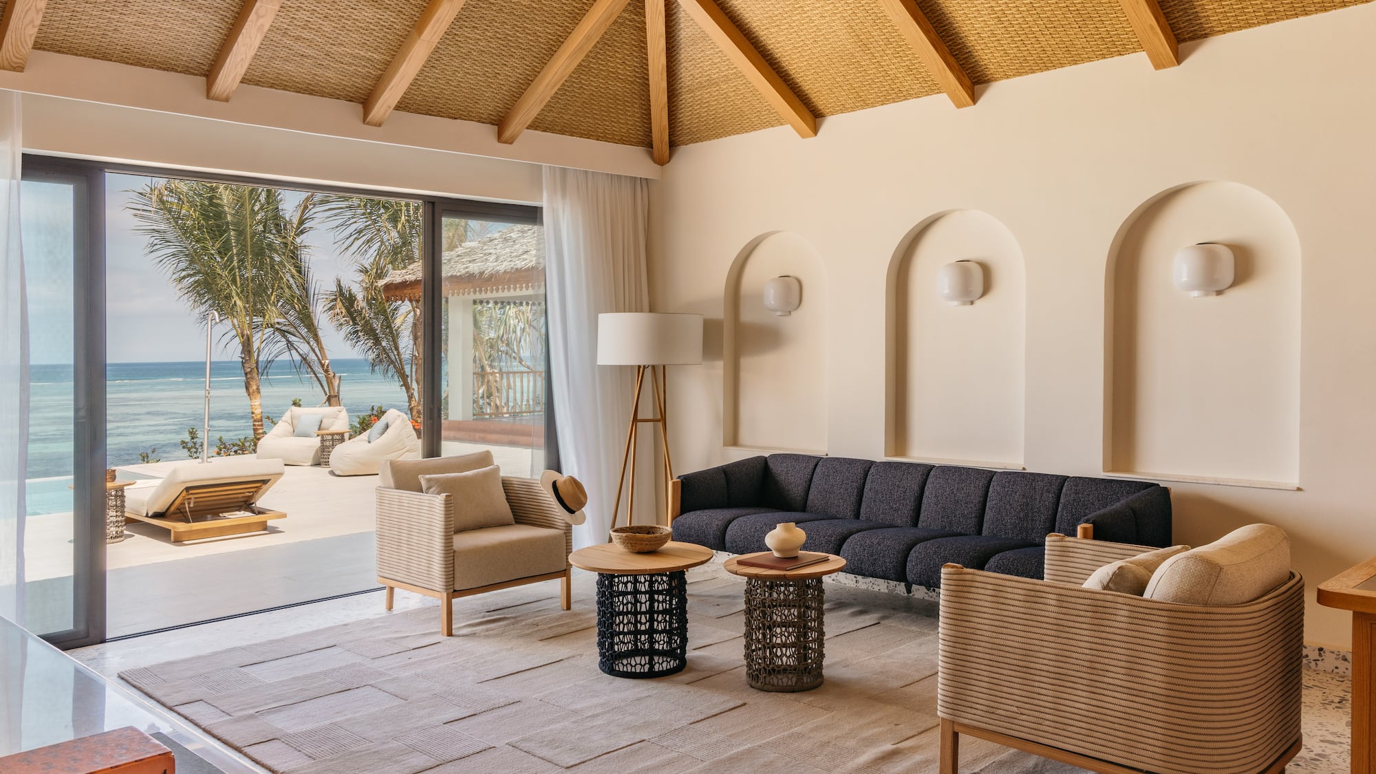 a living room with a large window overlooking the ocean