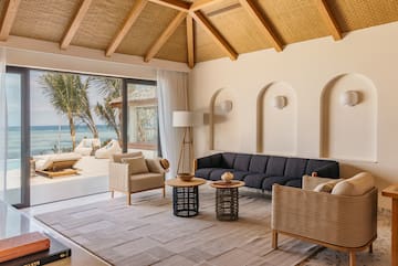 a living room with a large window overlooking the ocean