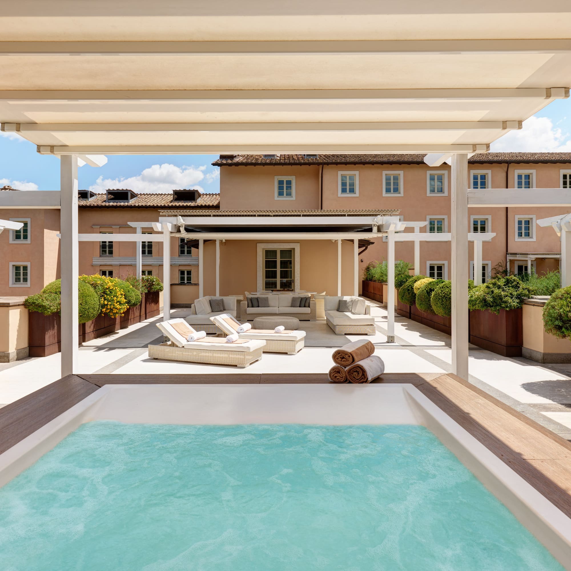 a pool with a deck and a patio with a large building