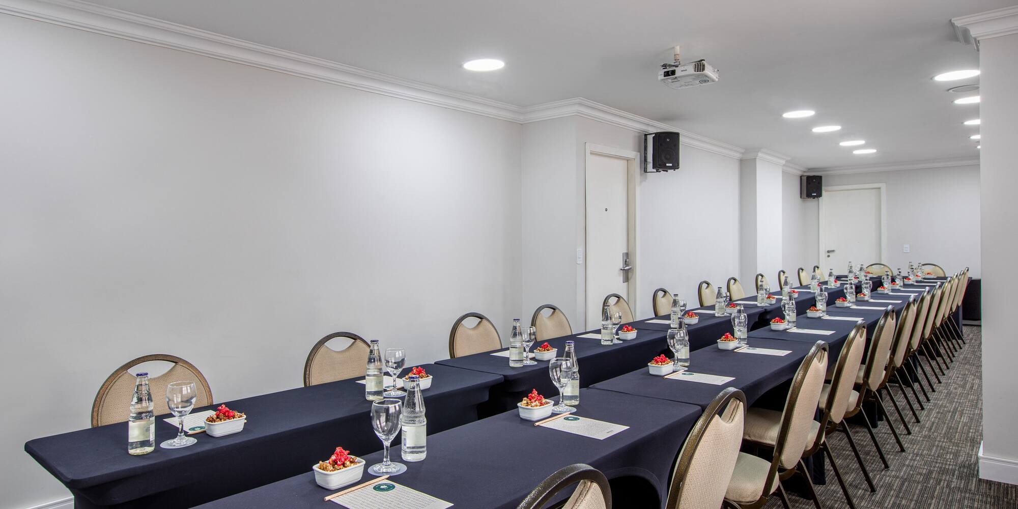 a long conference room with chairs and tables