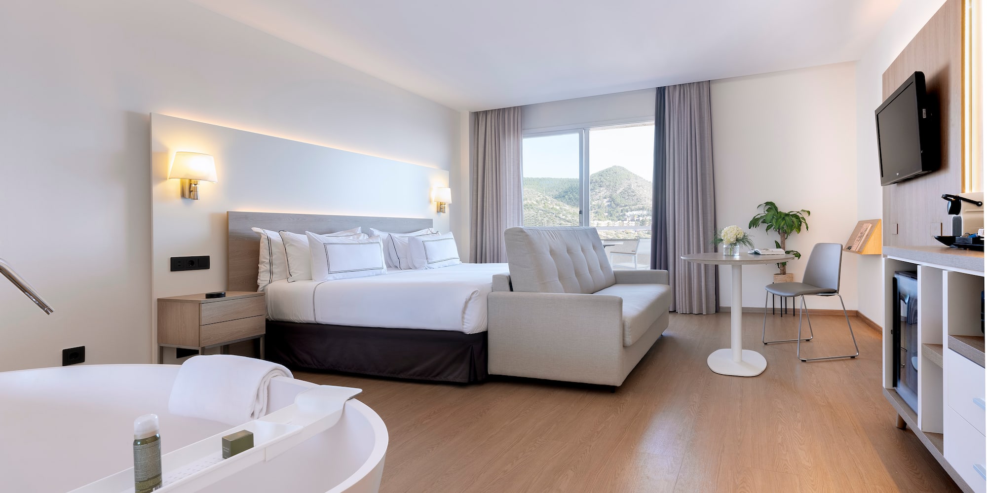 a room with a bed and a bathtub