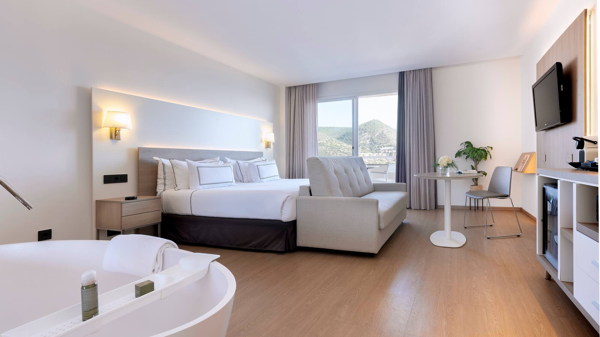 a room with a bed and a bathtub