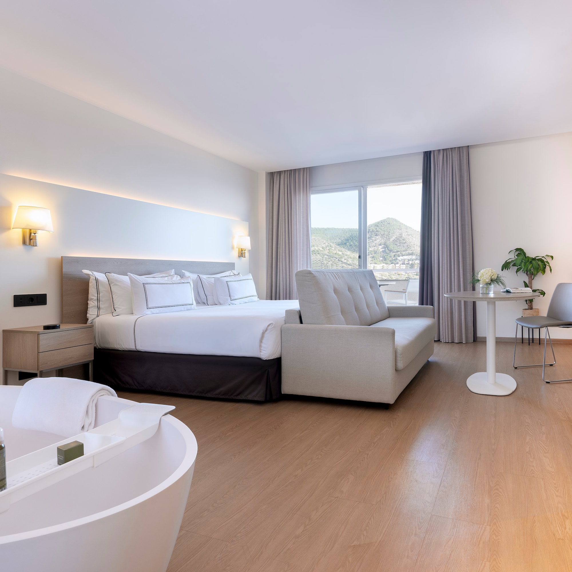 a room with a bed and a bathtub