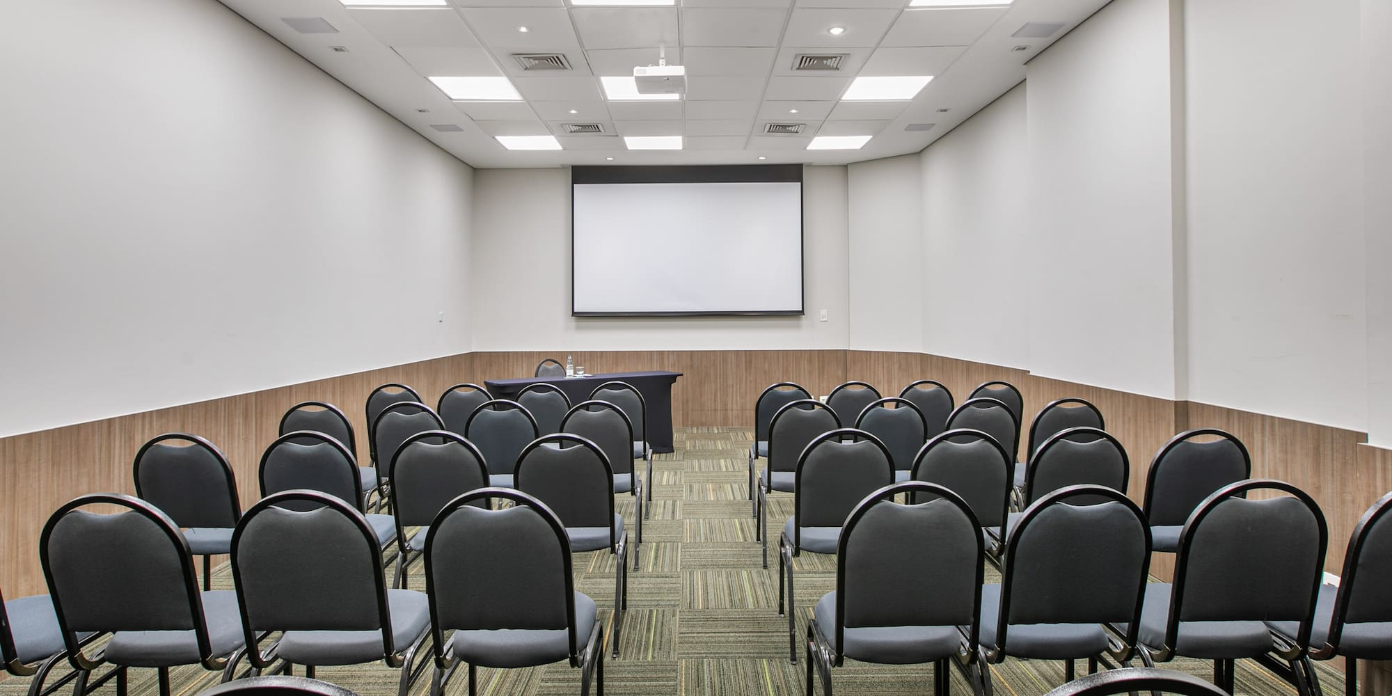 a room with chairs and a projector screen