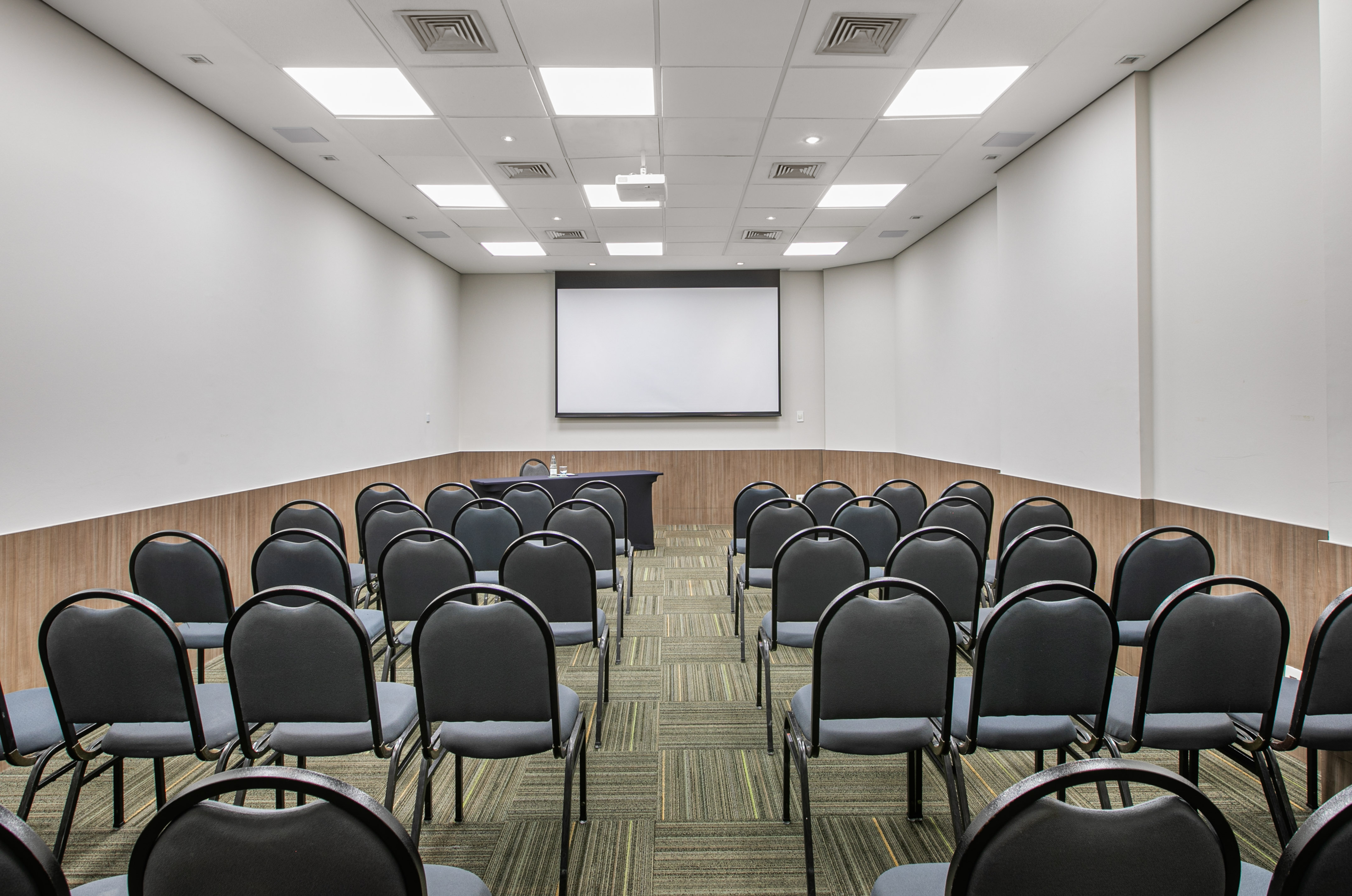 a room with chairs and a projector screen
