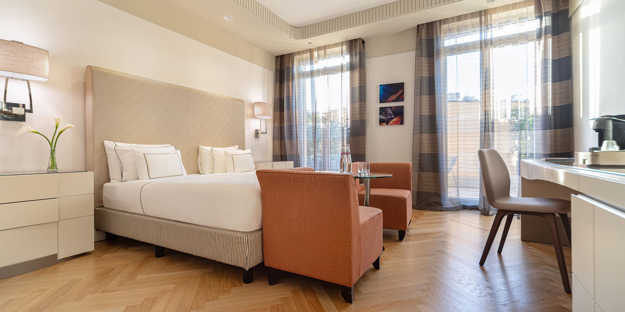 a room with a bed and chairs