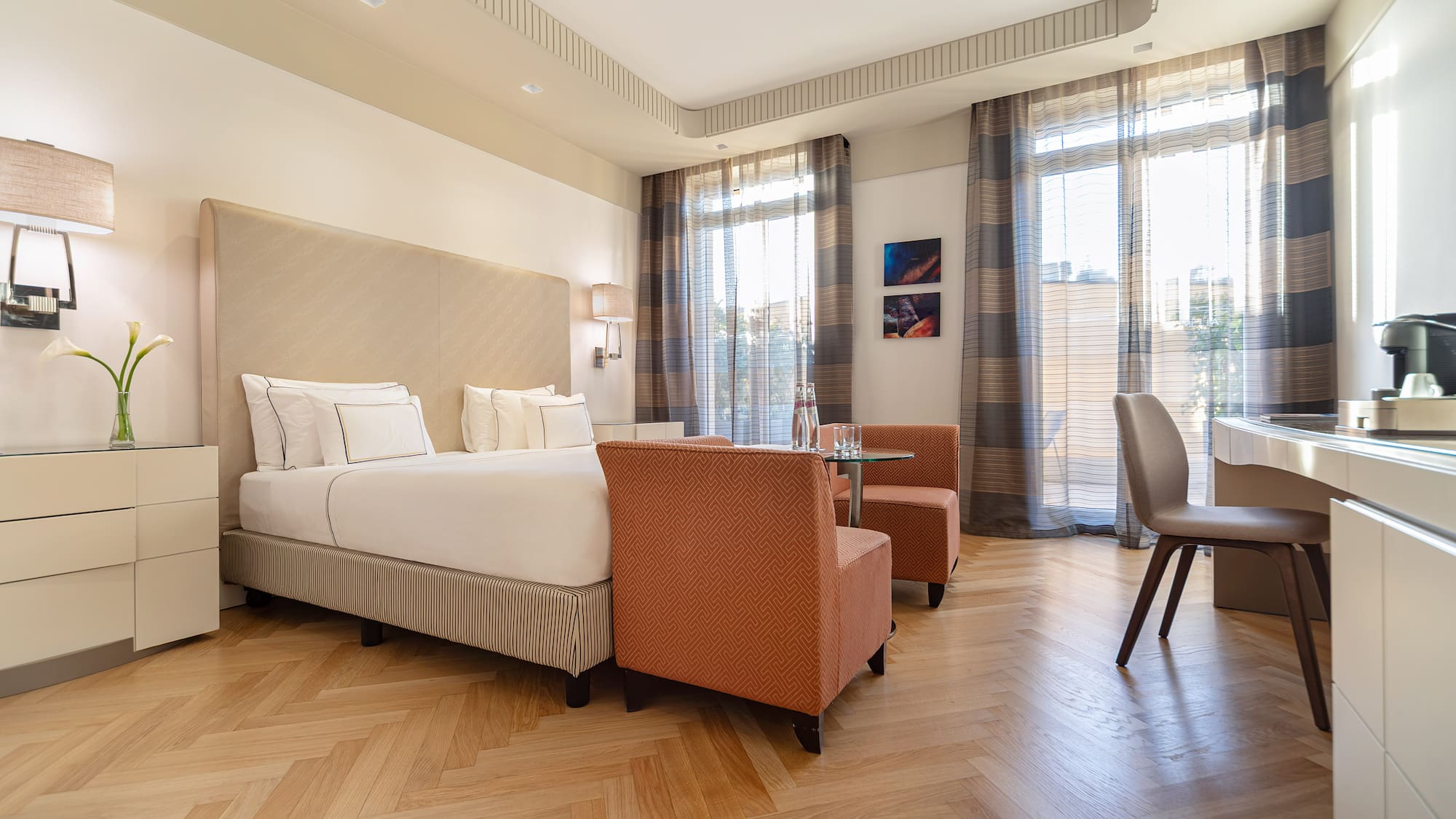 a room with a bed and chairs