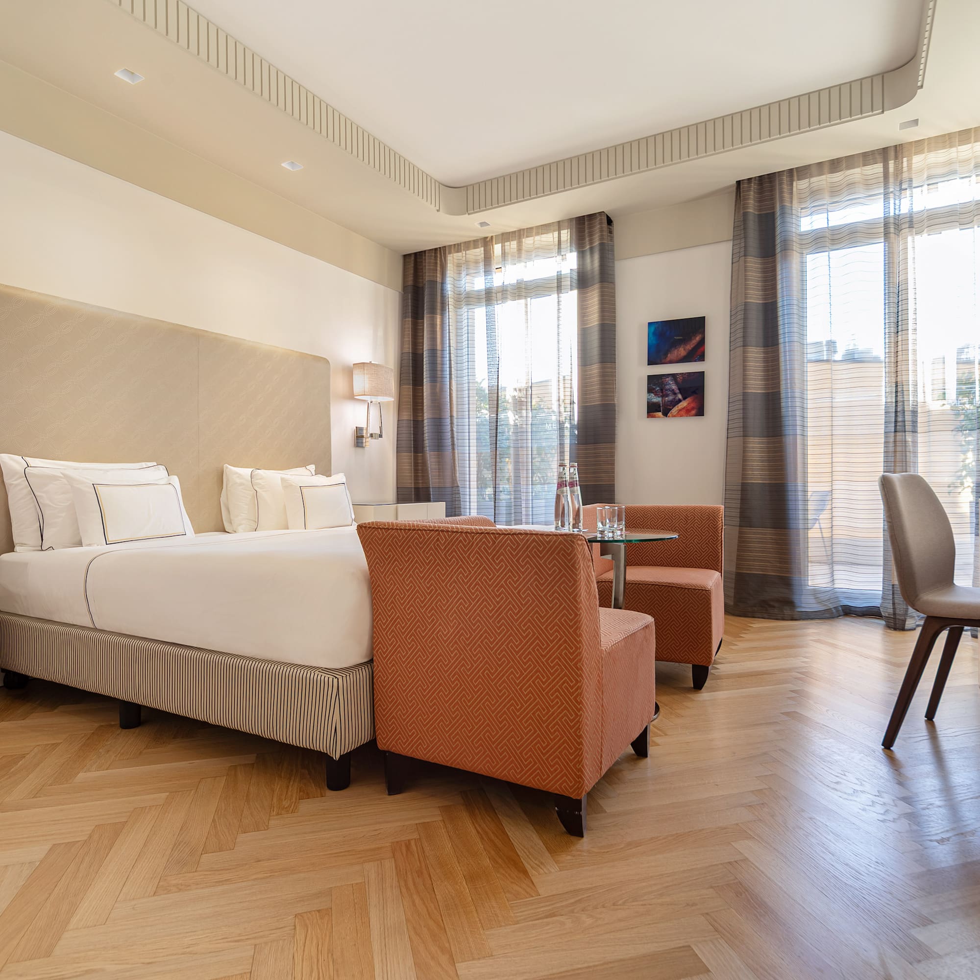 a room with a bed and chairs