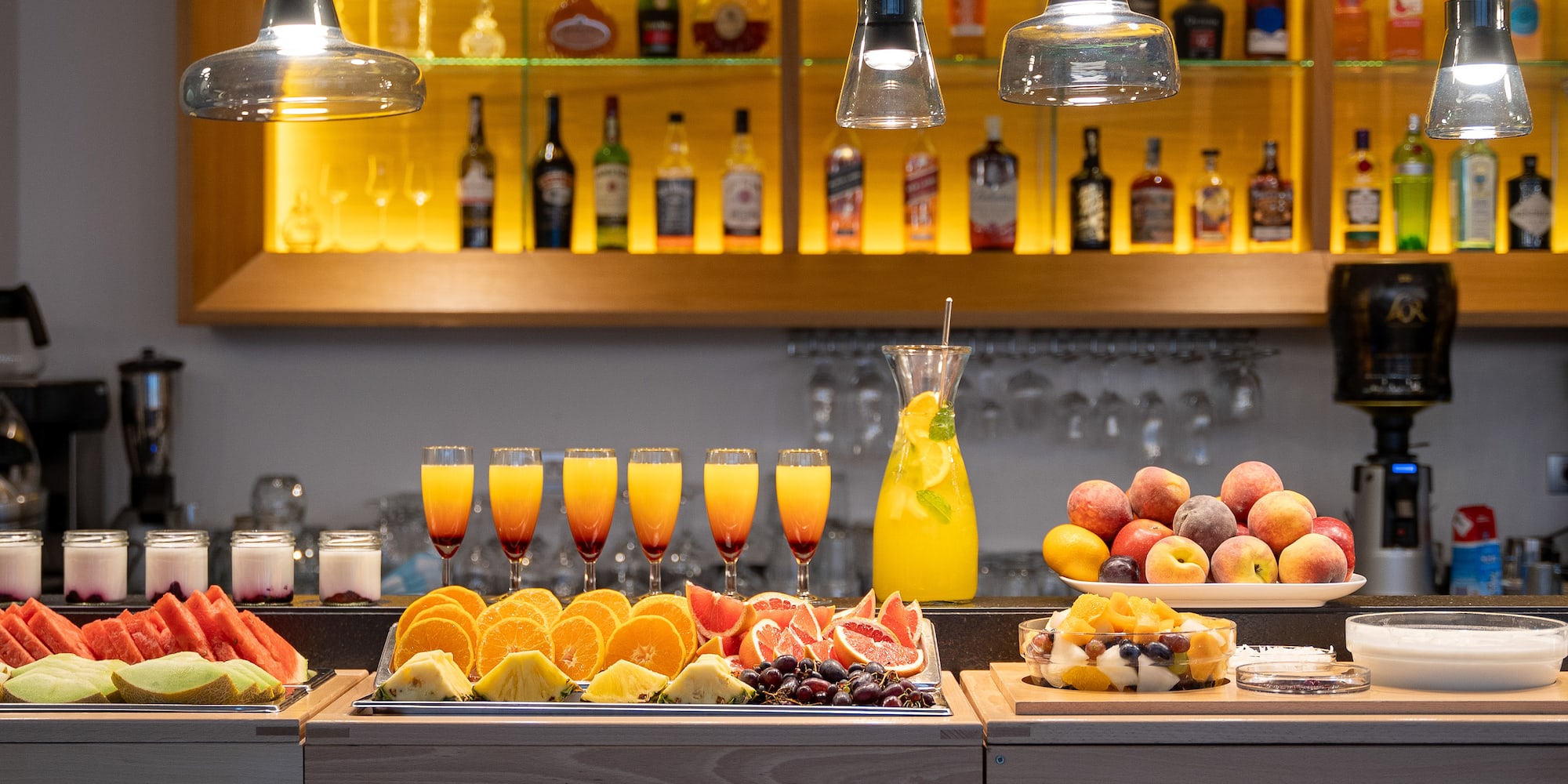 a table with fruit and drinks on it