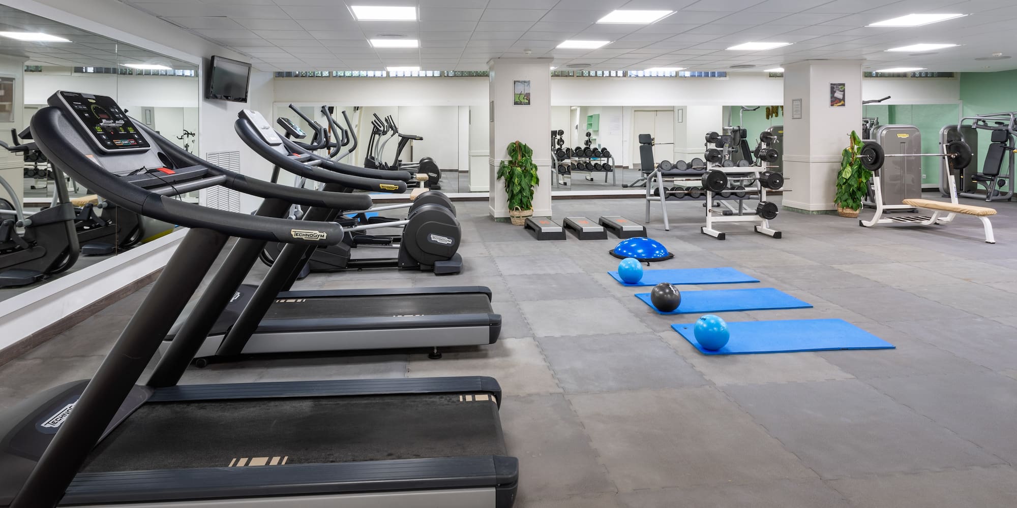 a room with treadmills and exercise equipment