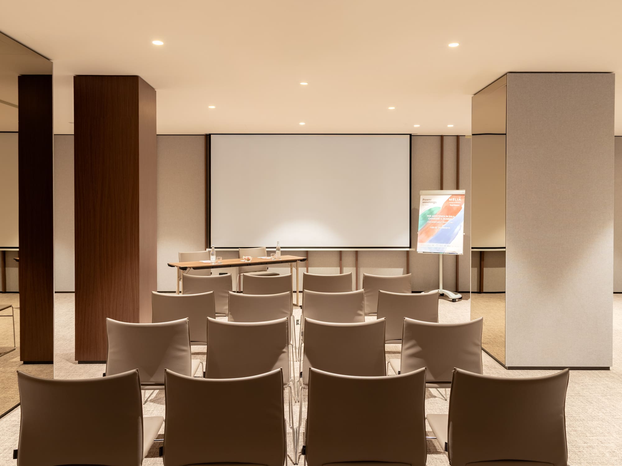 a room with chairs and a projector screen