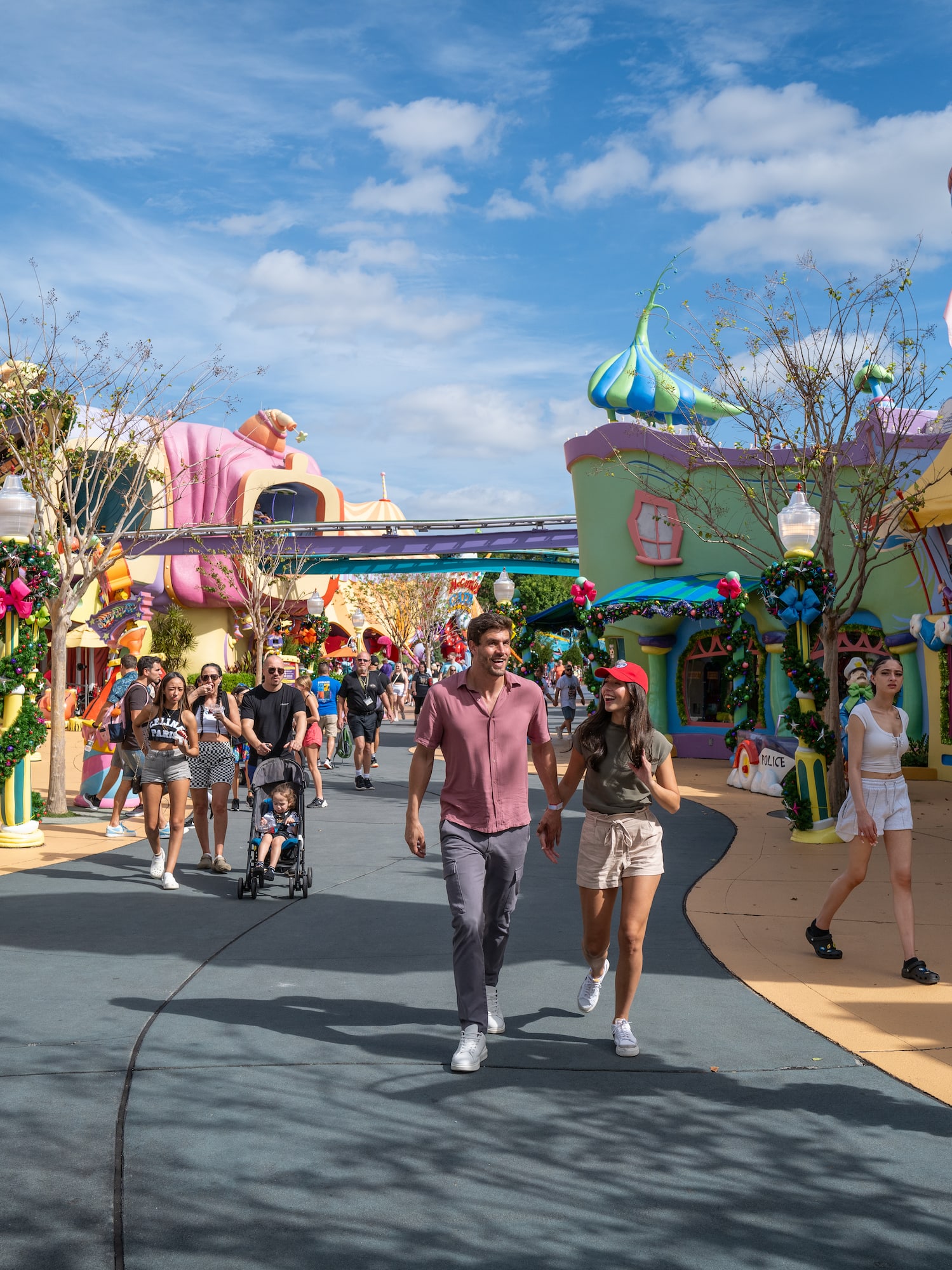 a man and woman walking on a road with colorful buildings