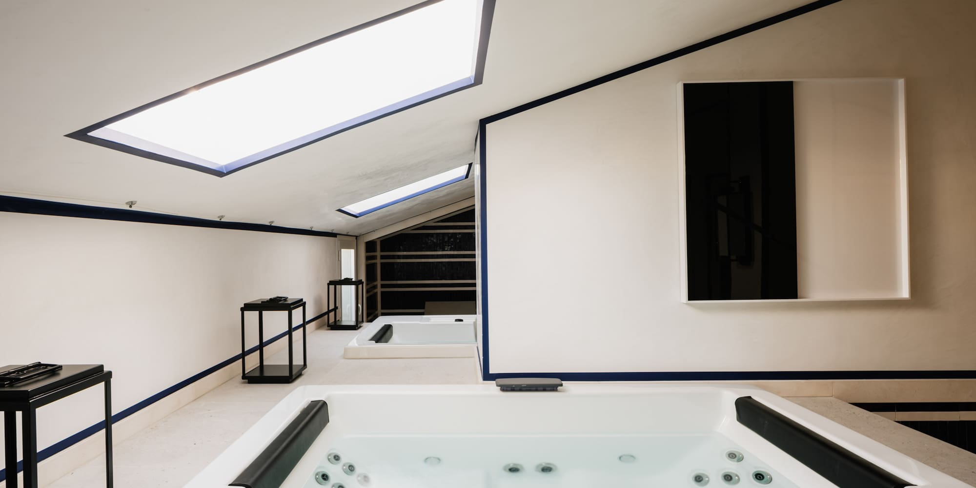 a room with a hot tub and a mirror