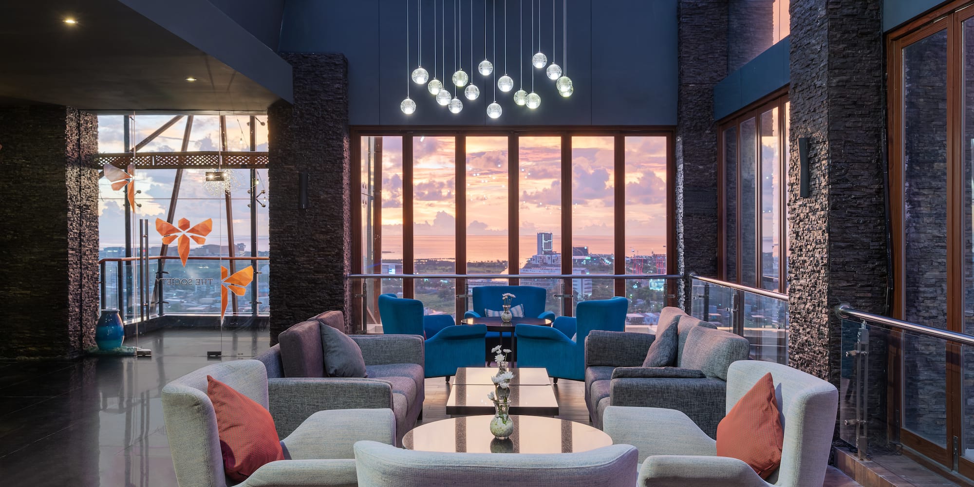 a room with a large window and a couch and chairs