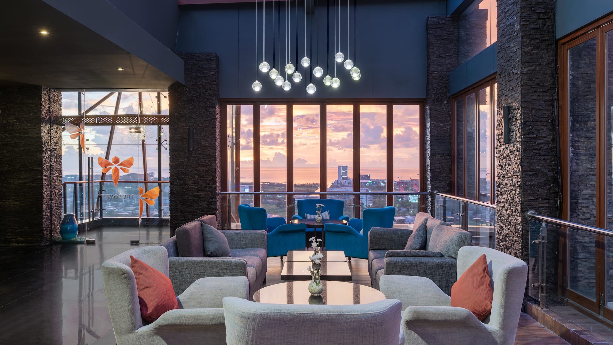 a room with a large window and a couch and chairs