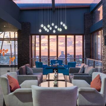 a room with a large window and a couch and chairs