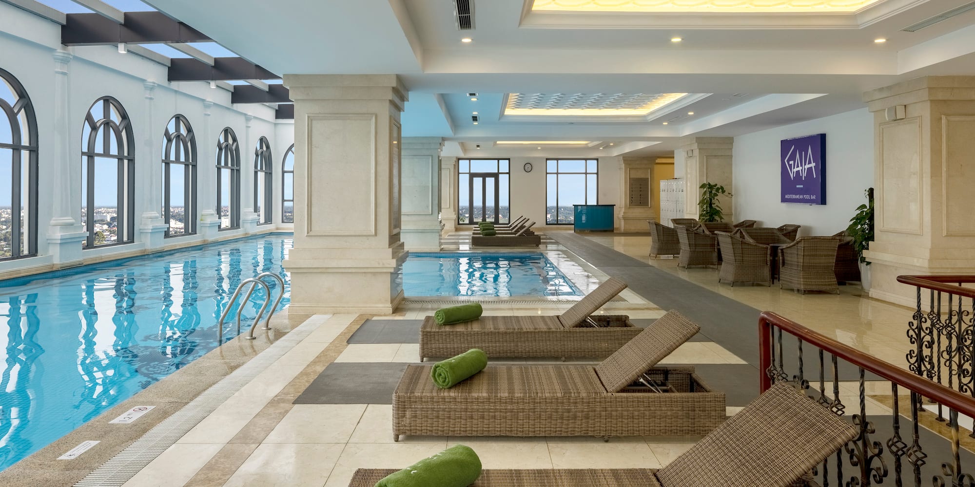 a pool with lounge chairs and chairs