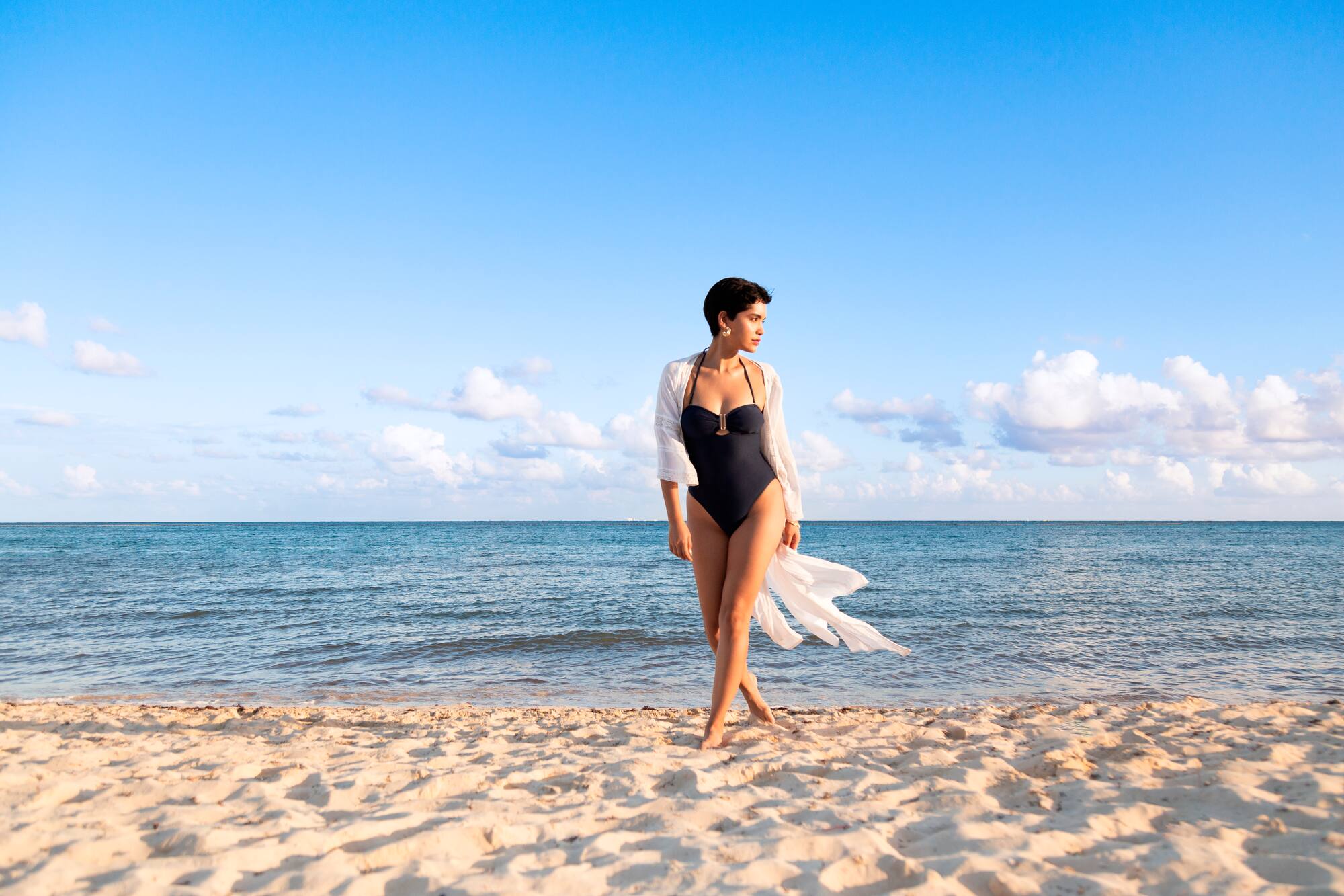 a woman in a swimsuit on a beach