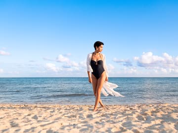 a woman in a swimsuit on a beach