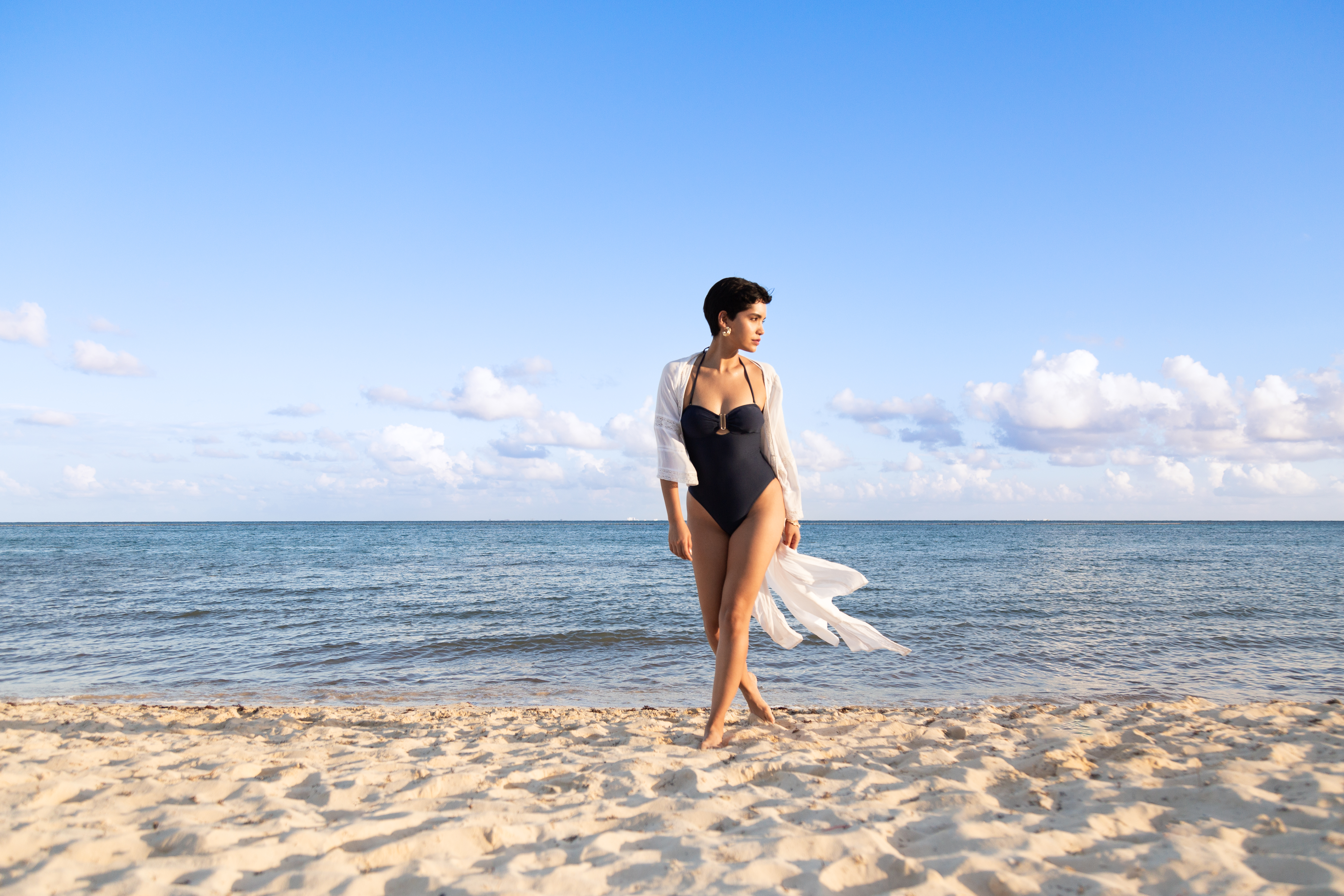 a woman in a swimsuit on a beach