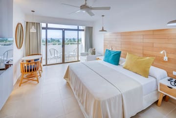 a bedroom with a bed and a ceiling fan