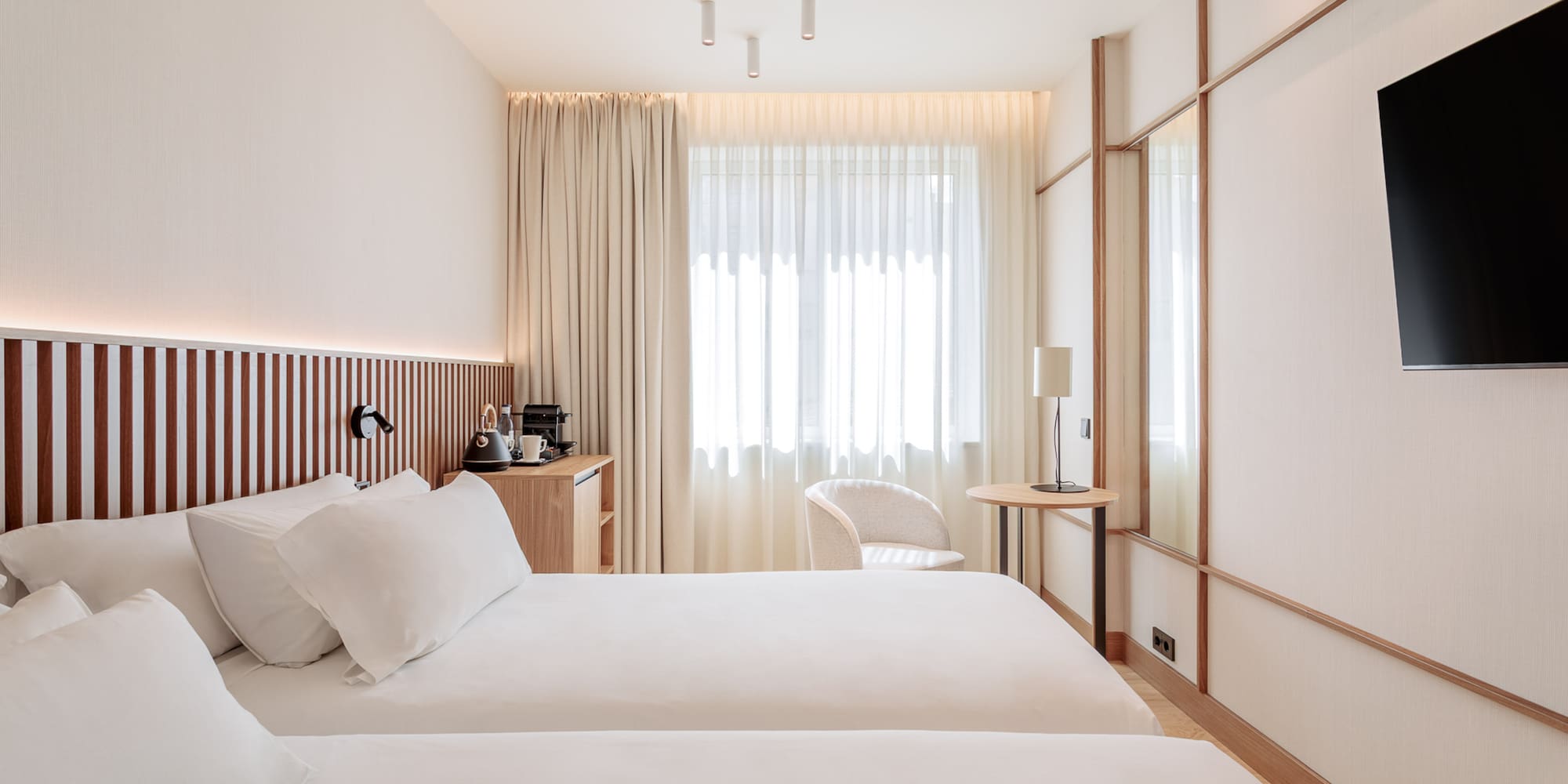 a room with two beds and a table