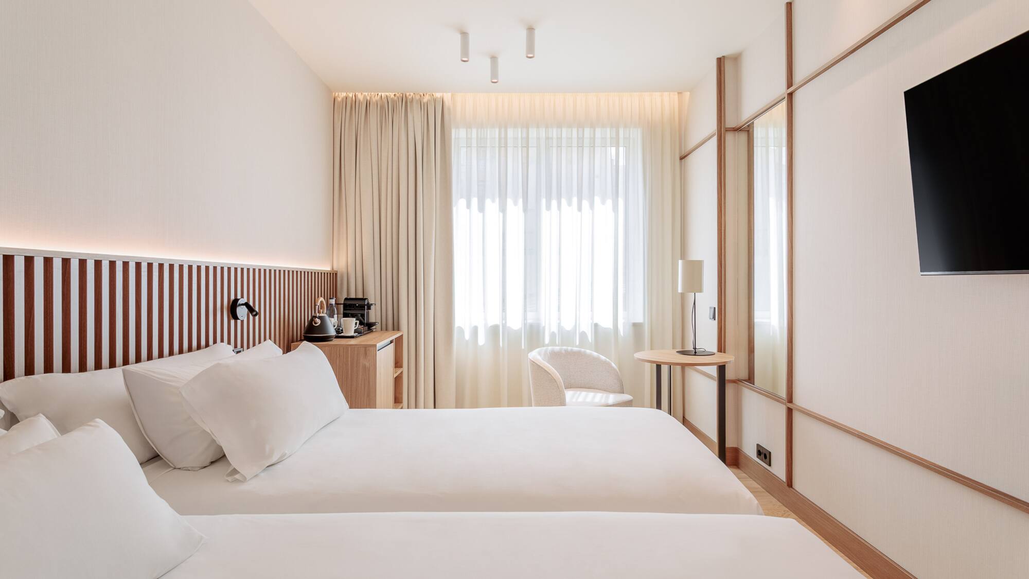 a room with two beds and a table