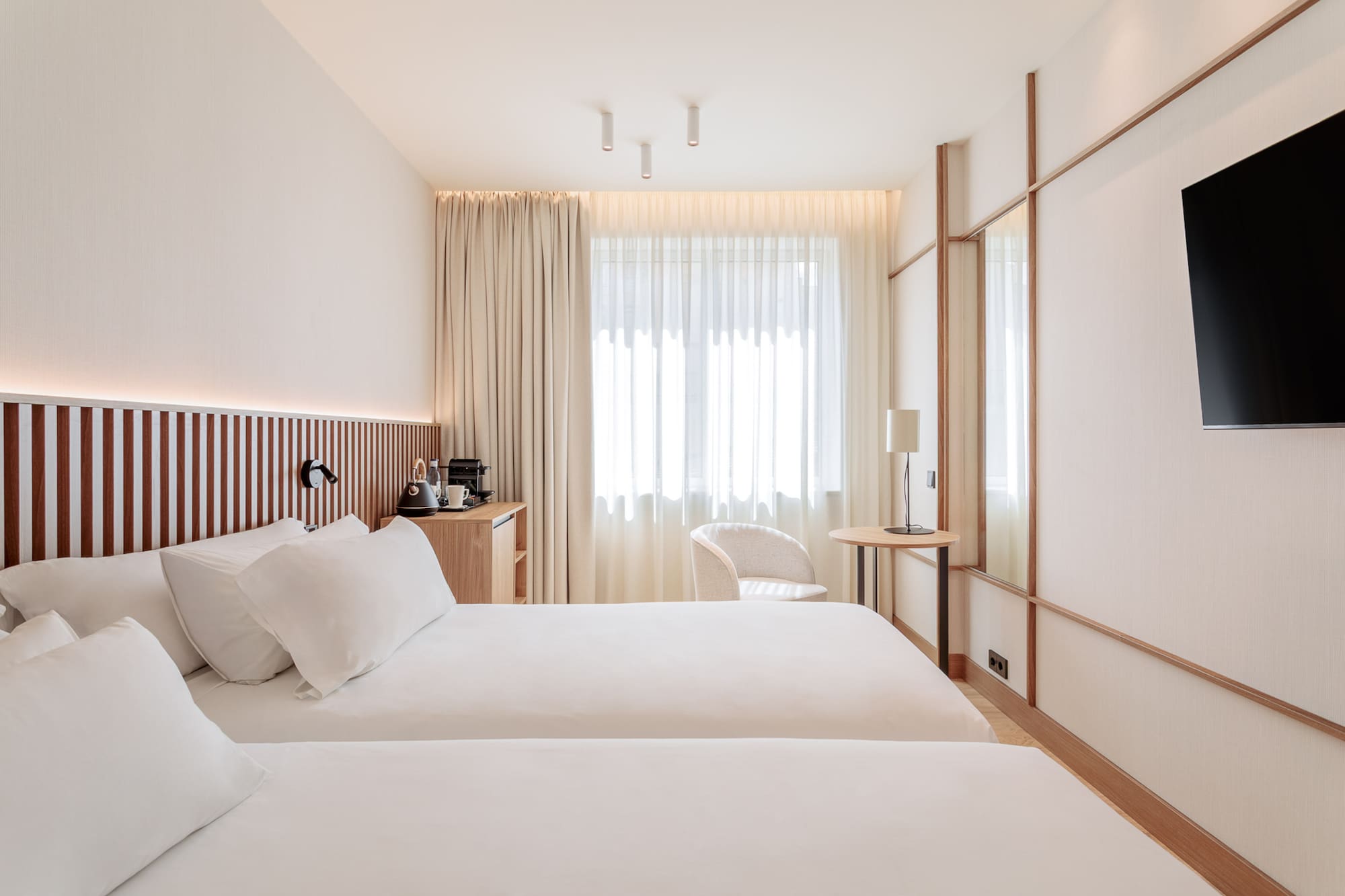 a room with two beds and a table