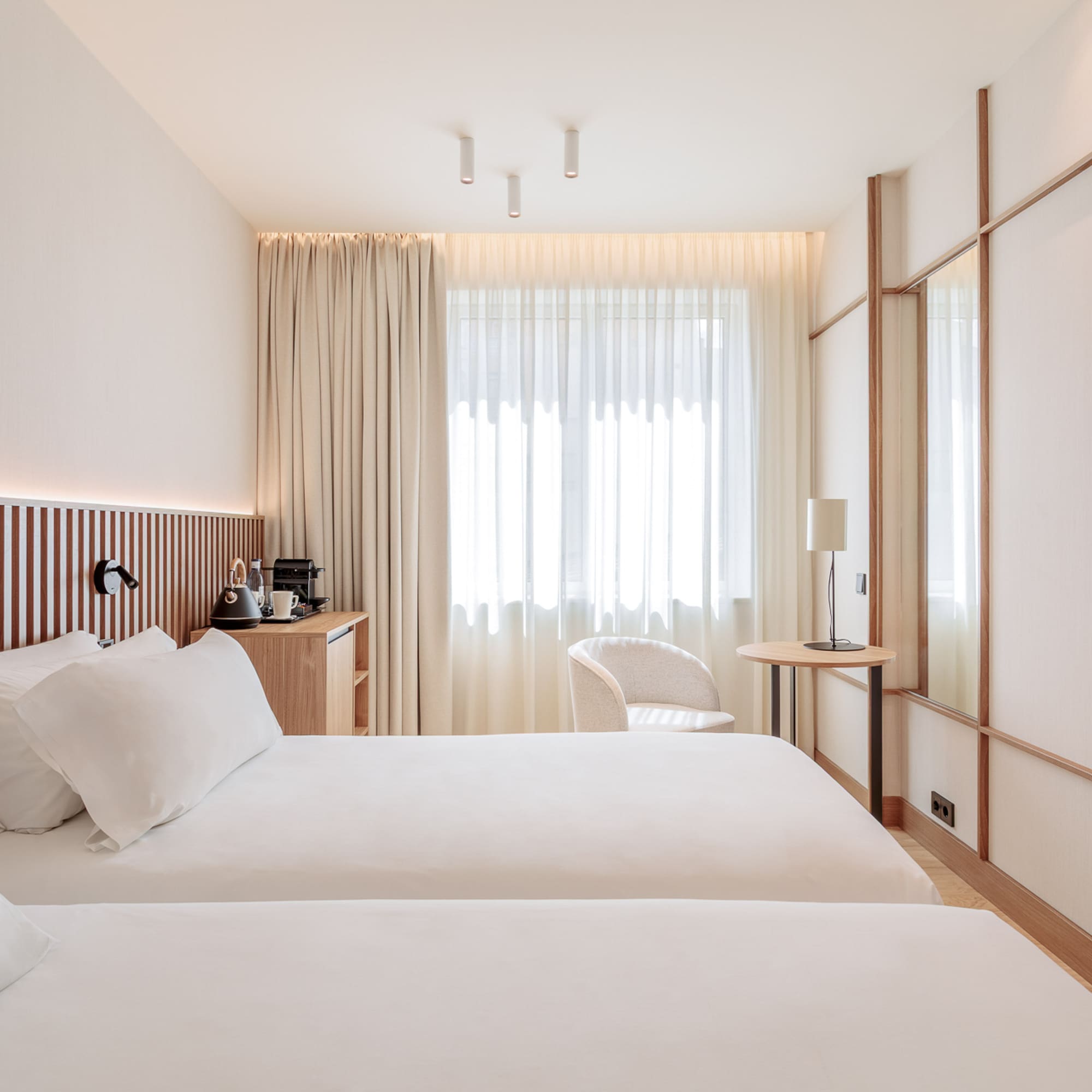 a room with two beds and a table