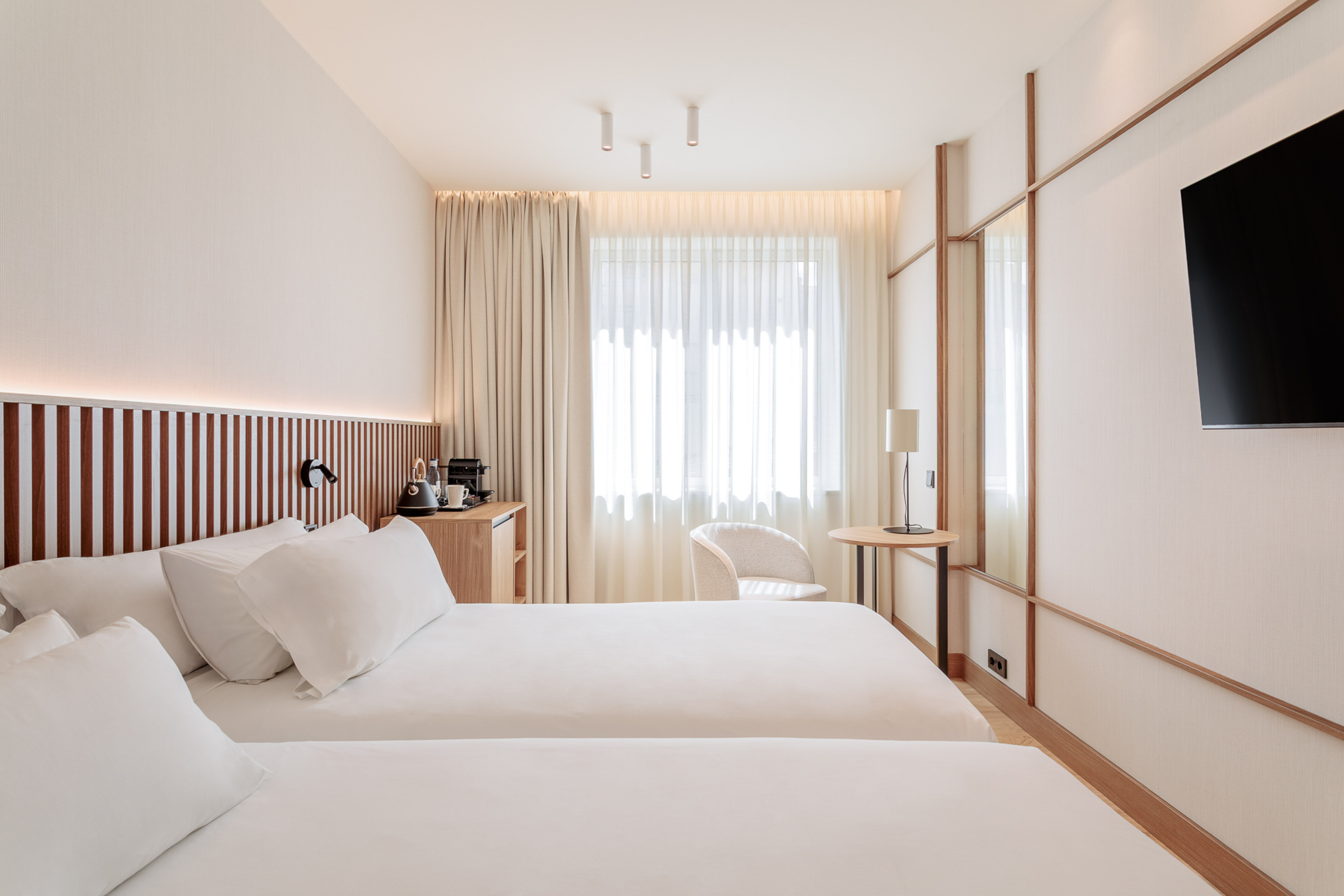 a room with two beds and a table