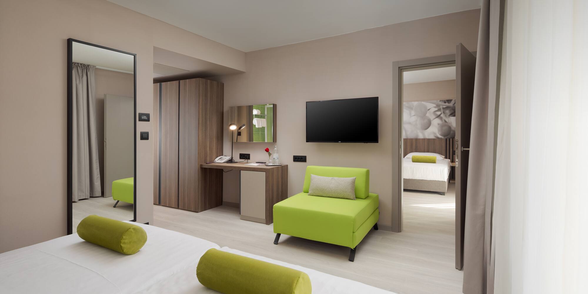 a room with green furniture and a tv