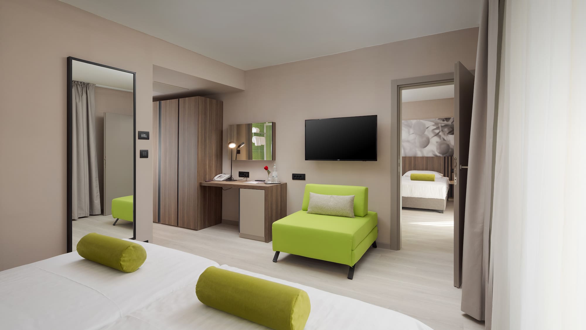 a room with green furniture and a tv