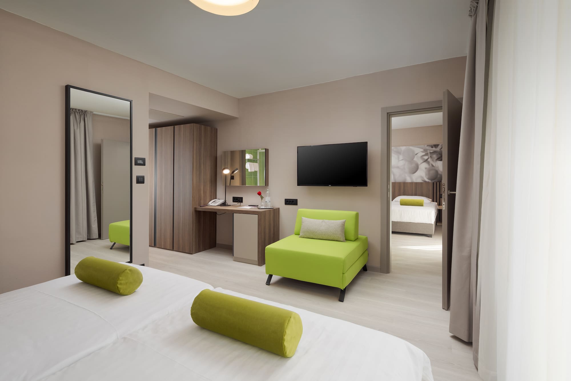 a room with green furniture and a tv