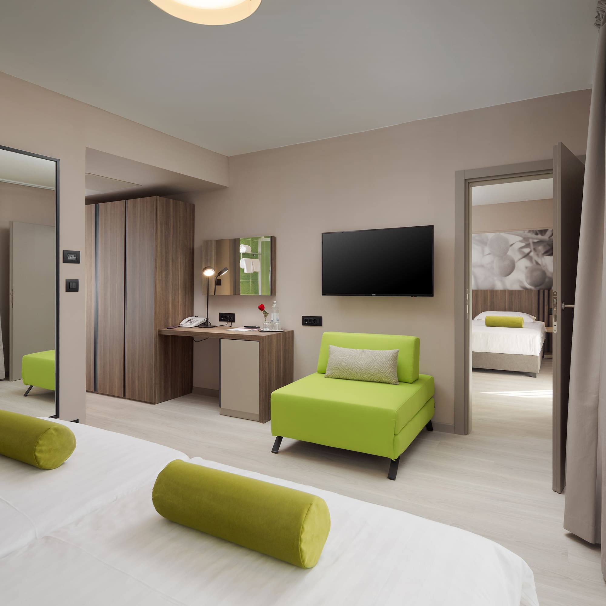 a room with green furniture and a tv