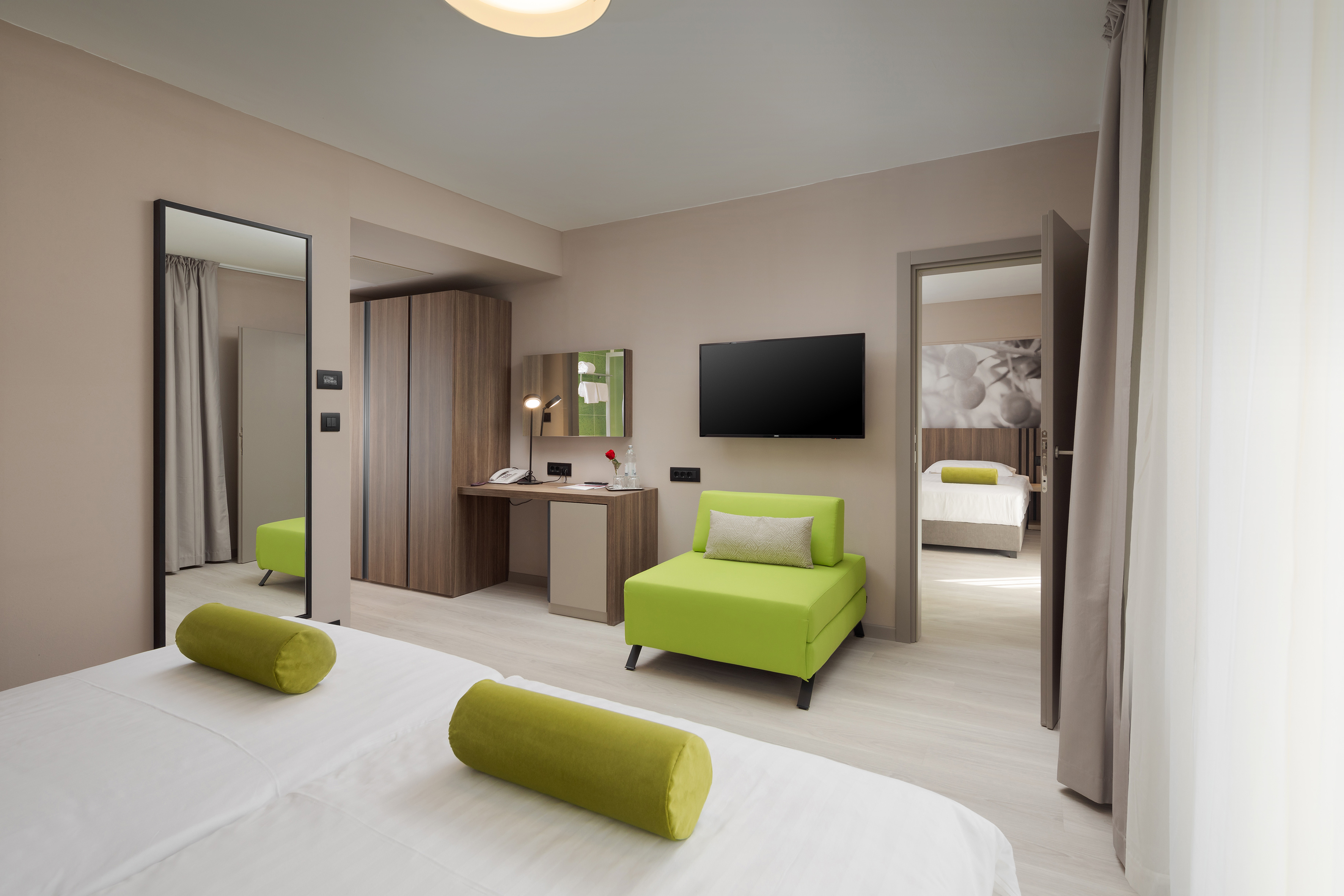 a room with green furniture and a tv