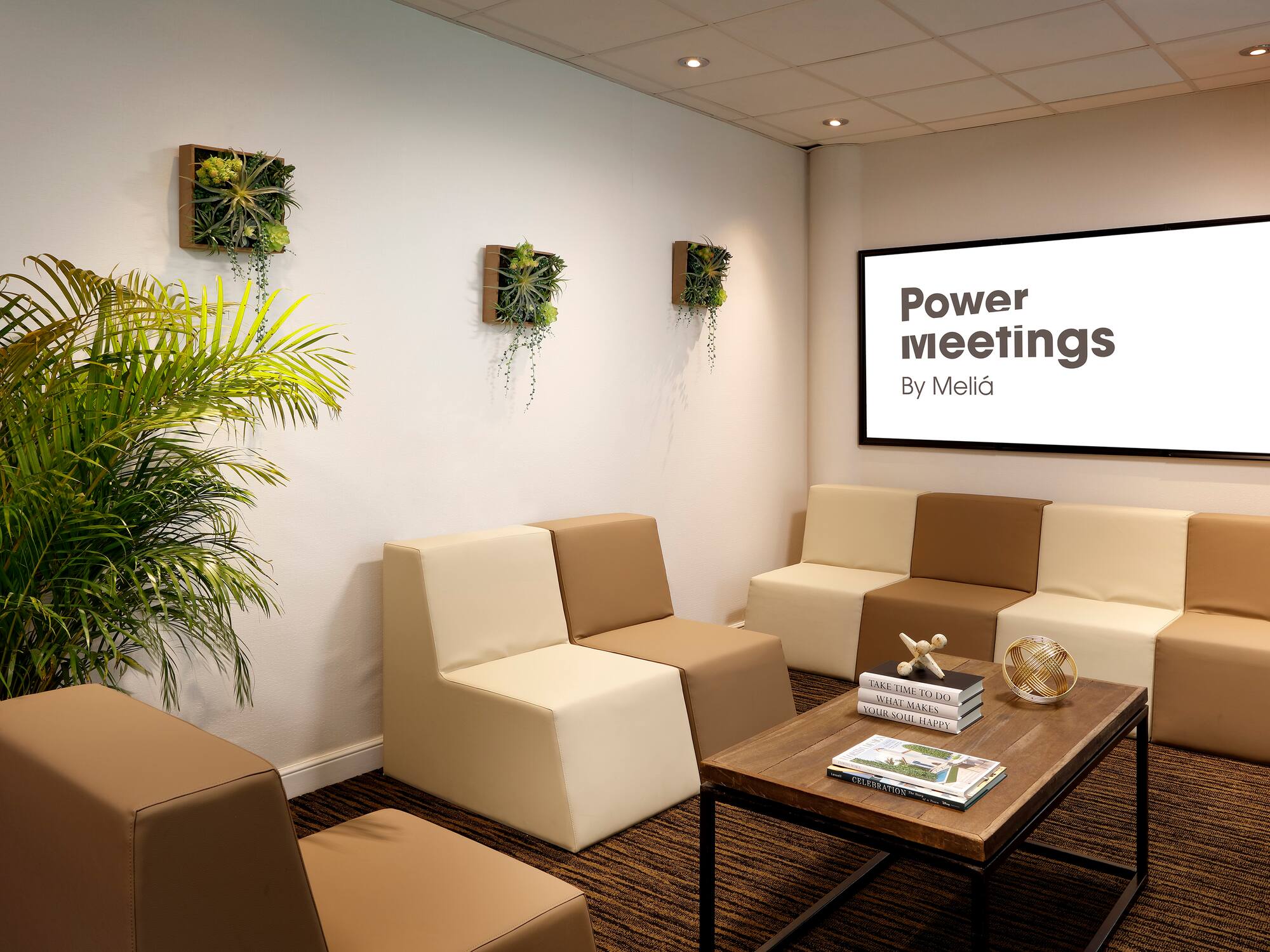 a room with couches and a screen