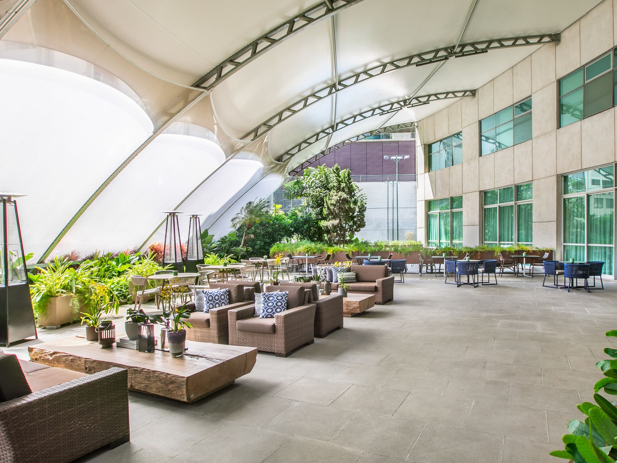 a patio area with tables and chairs
