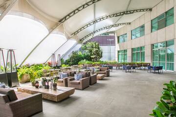 a patio area with tables and chairs