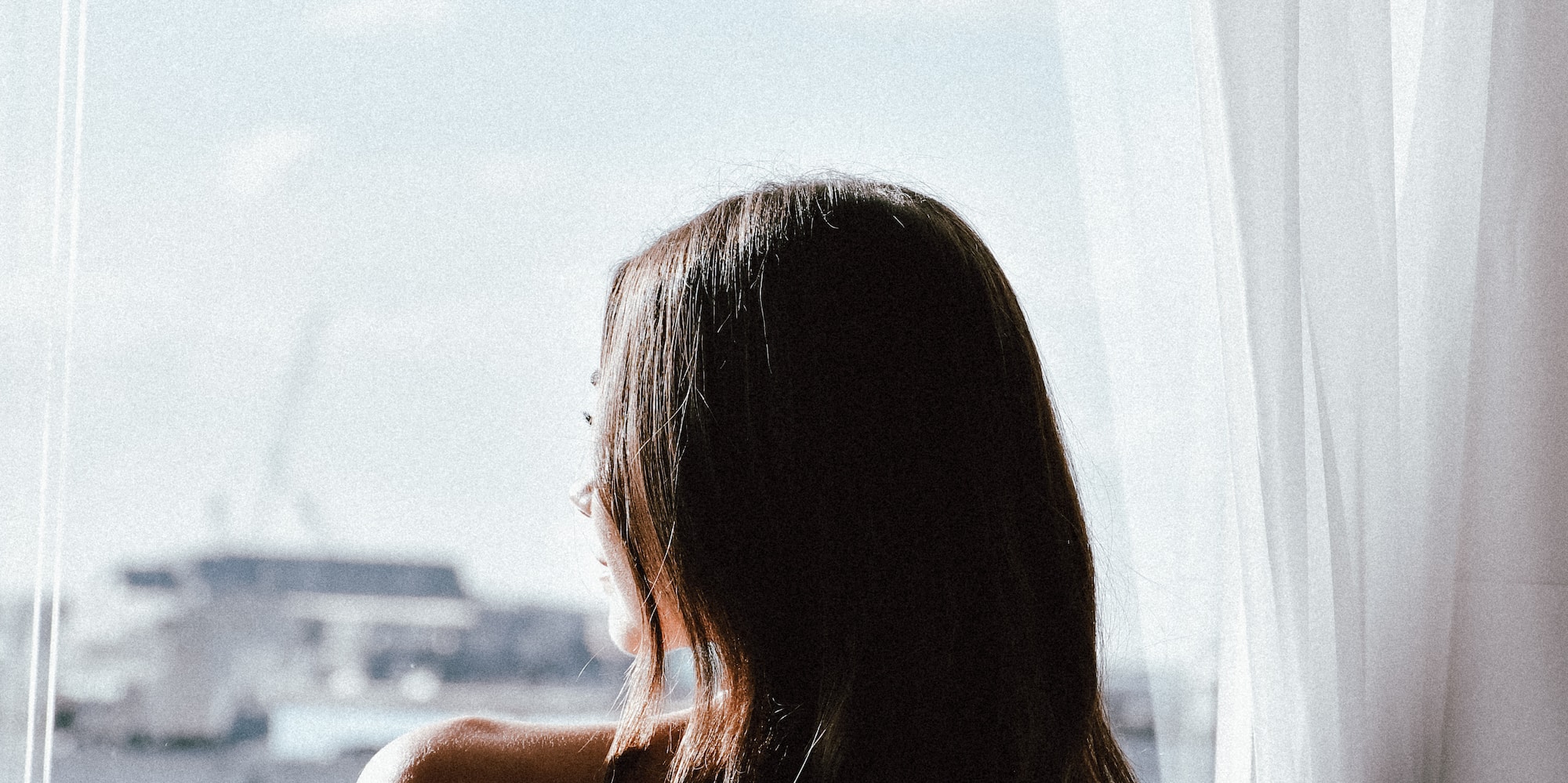 a woman looking out a window