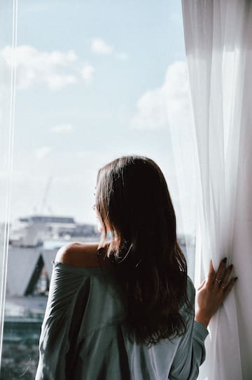 a woman looking out a window