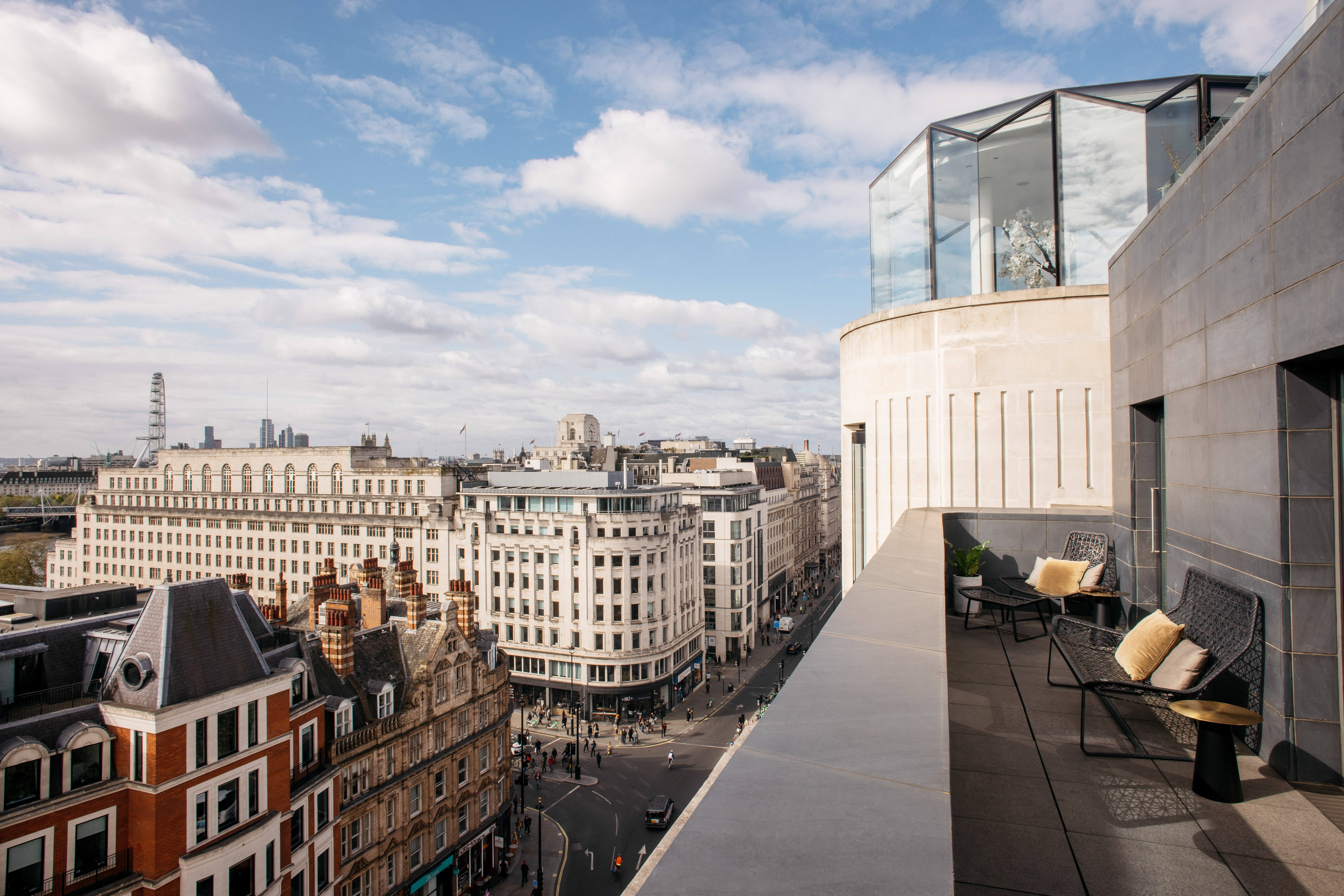London rooftop terrace, city view with London Eye and historic buildings.