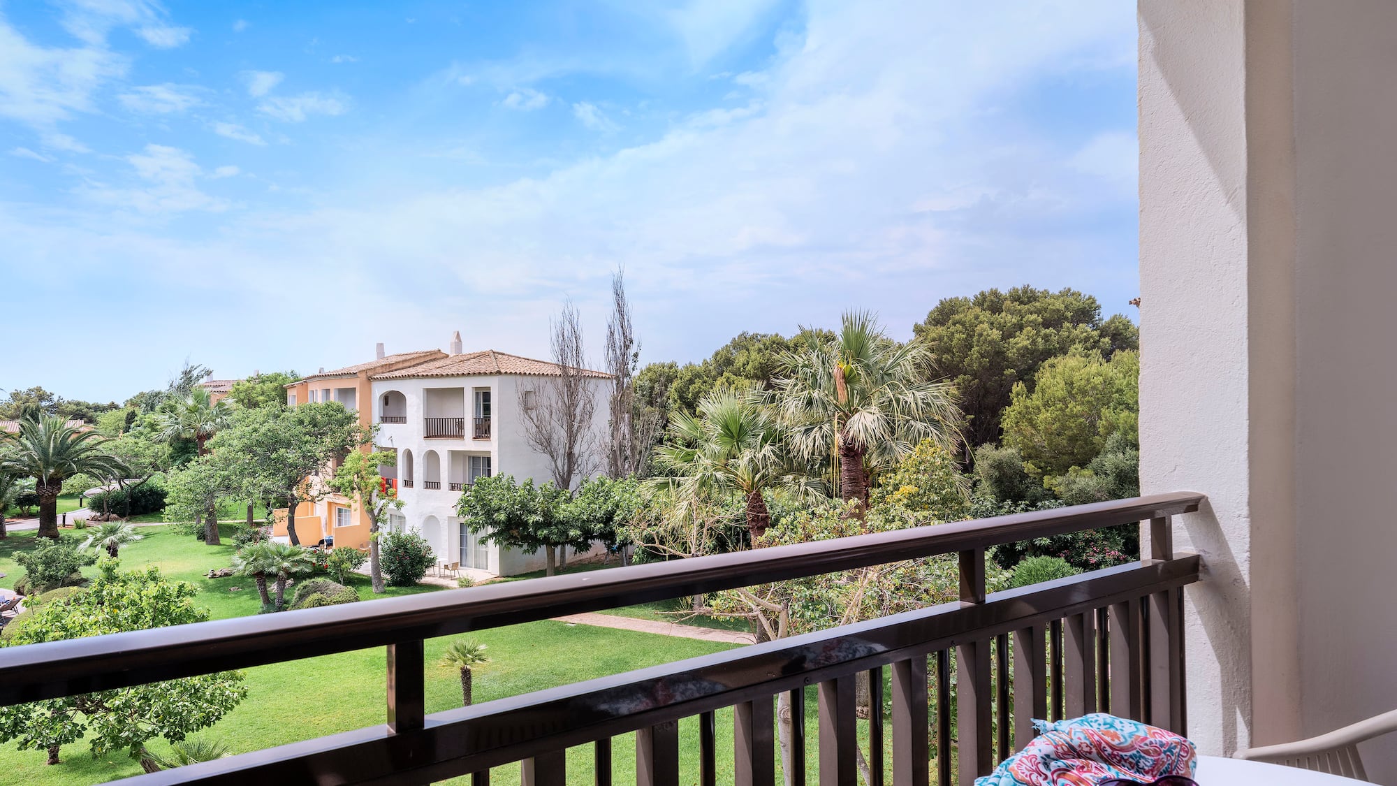 a balcony with a table and sunglasses on it
