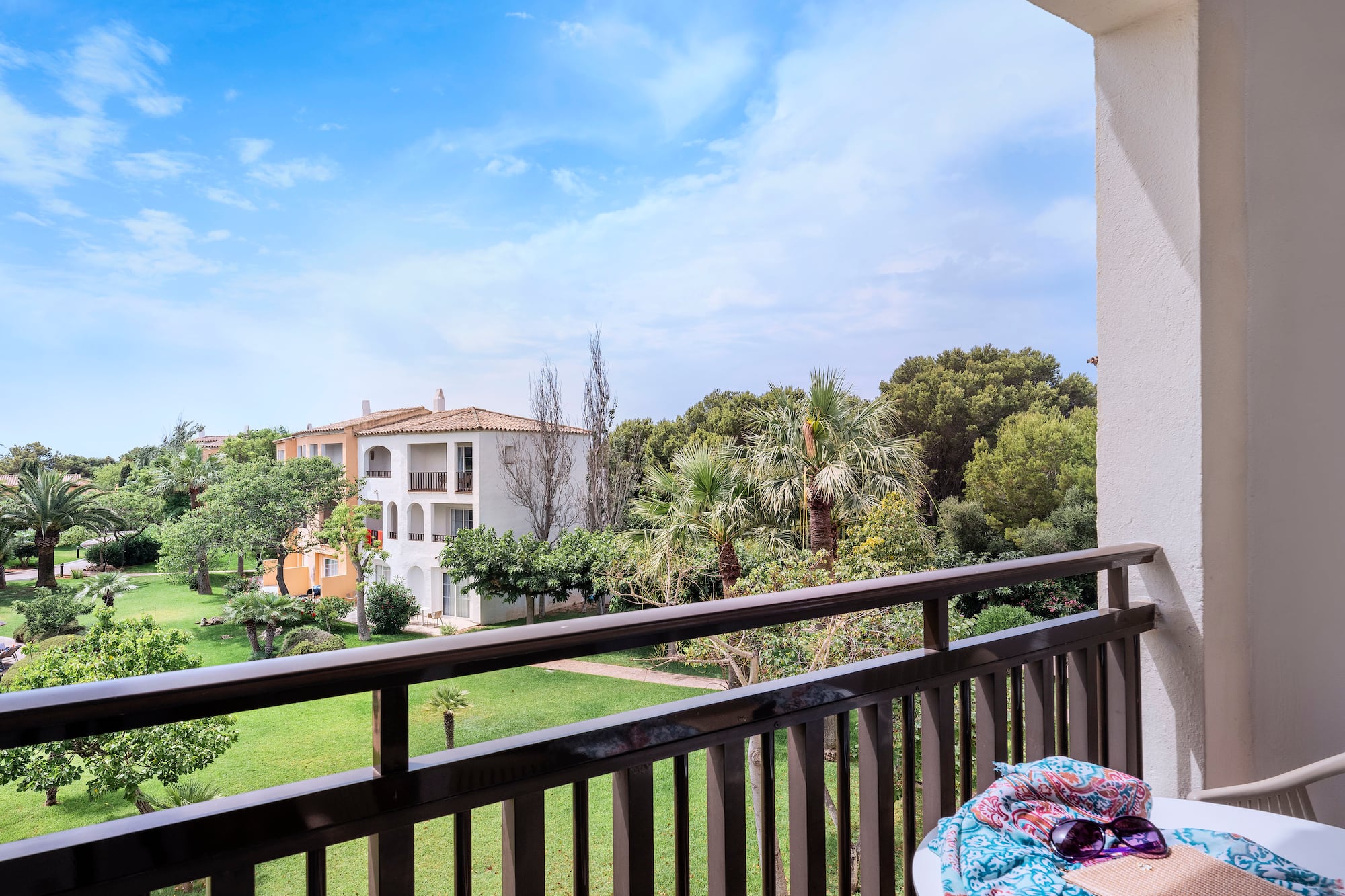 a balcony with a table and sunglasses on it