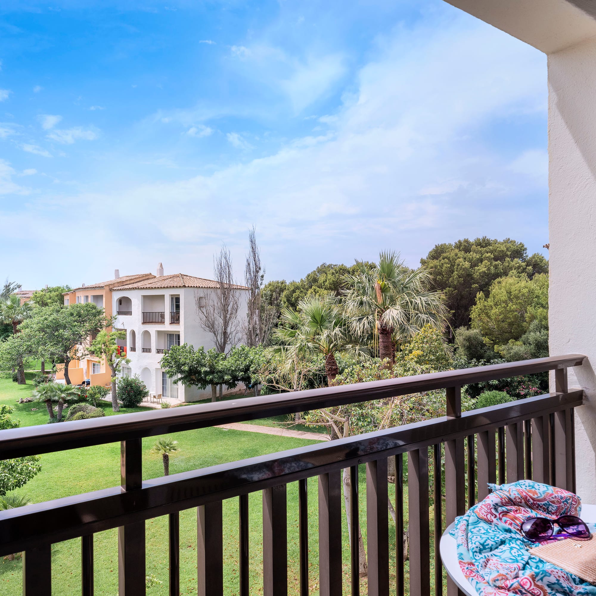 a balcony with a table and sunglasses on it