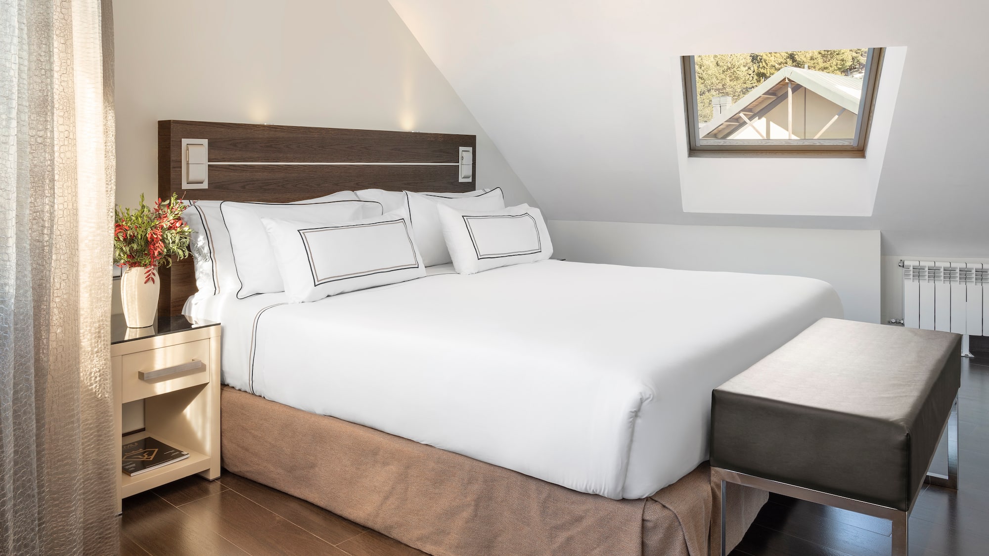 a bed with white sheets and a brown bedding