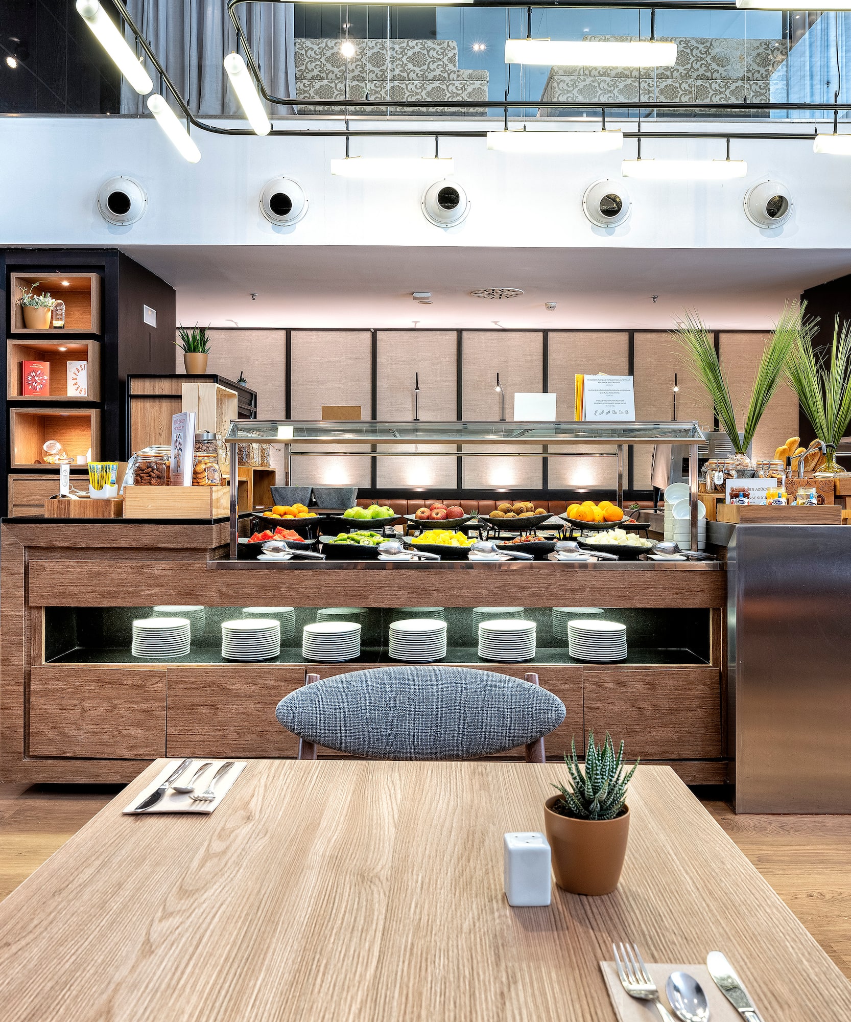 a restaurant with a table and a plant