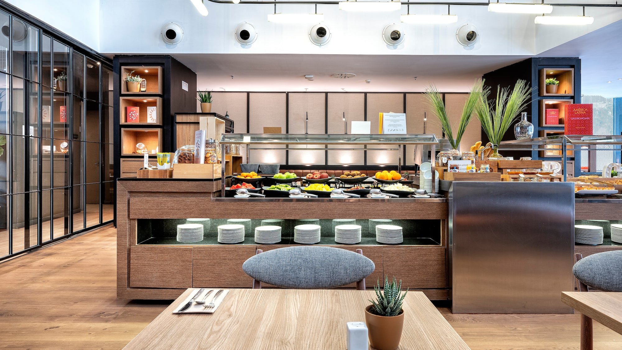 a restaurant with a table and a plant