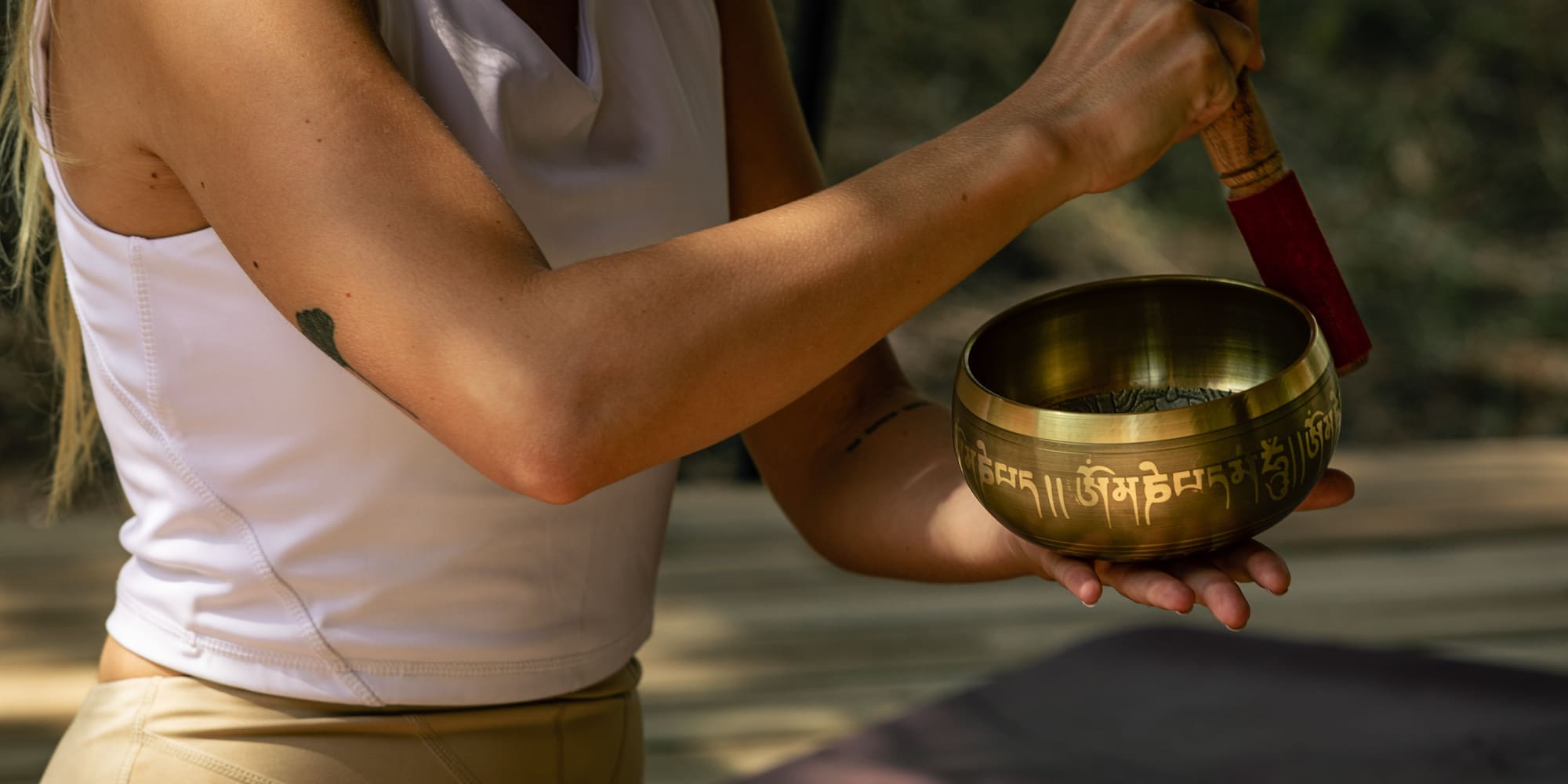 a person holding a singing bowl