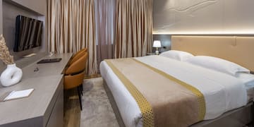 a room with a bed and a desk