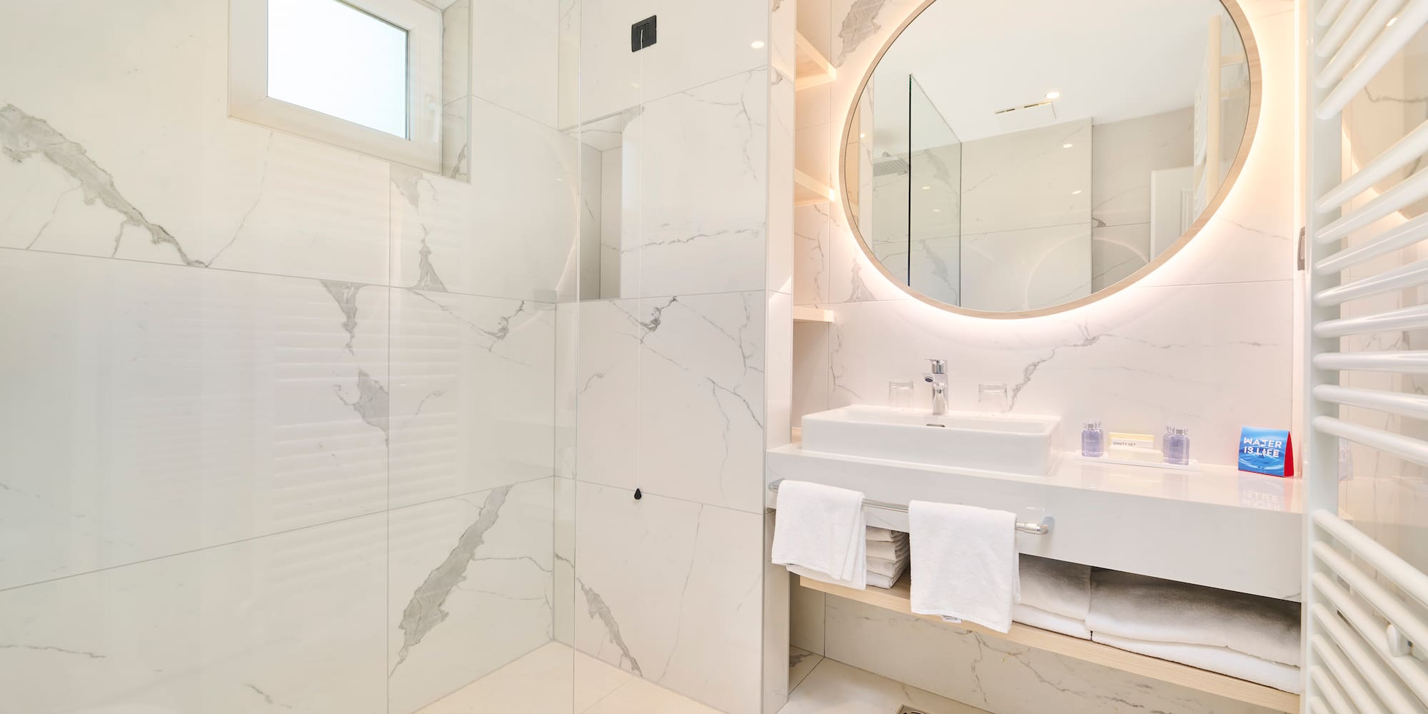 a bathroom with a round mirror